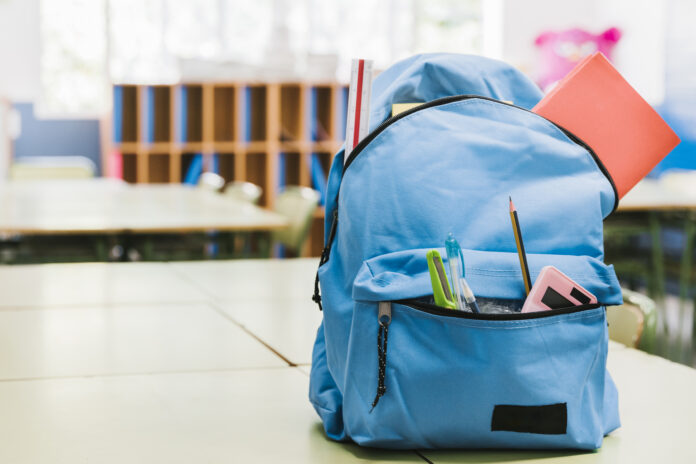 blue-schoolchild-backpack-table